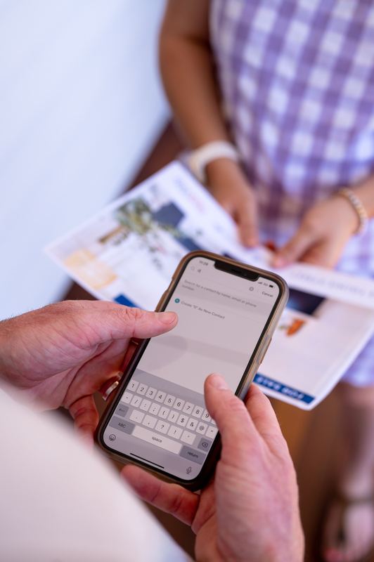 RealWay agent taking a buyer's details at an open home