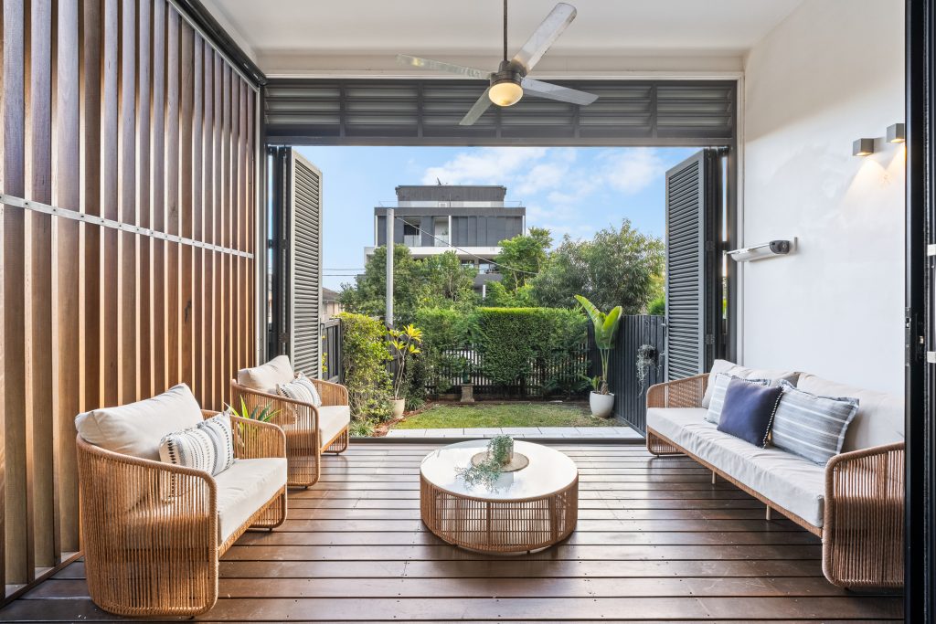 Covered timber deck with outdoor lounge seating at an East Gosford home