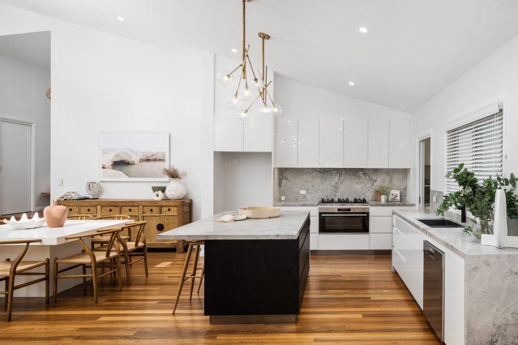 Open plan kitchen and dining area with raked ceiling in a Lisarow home