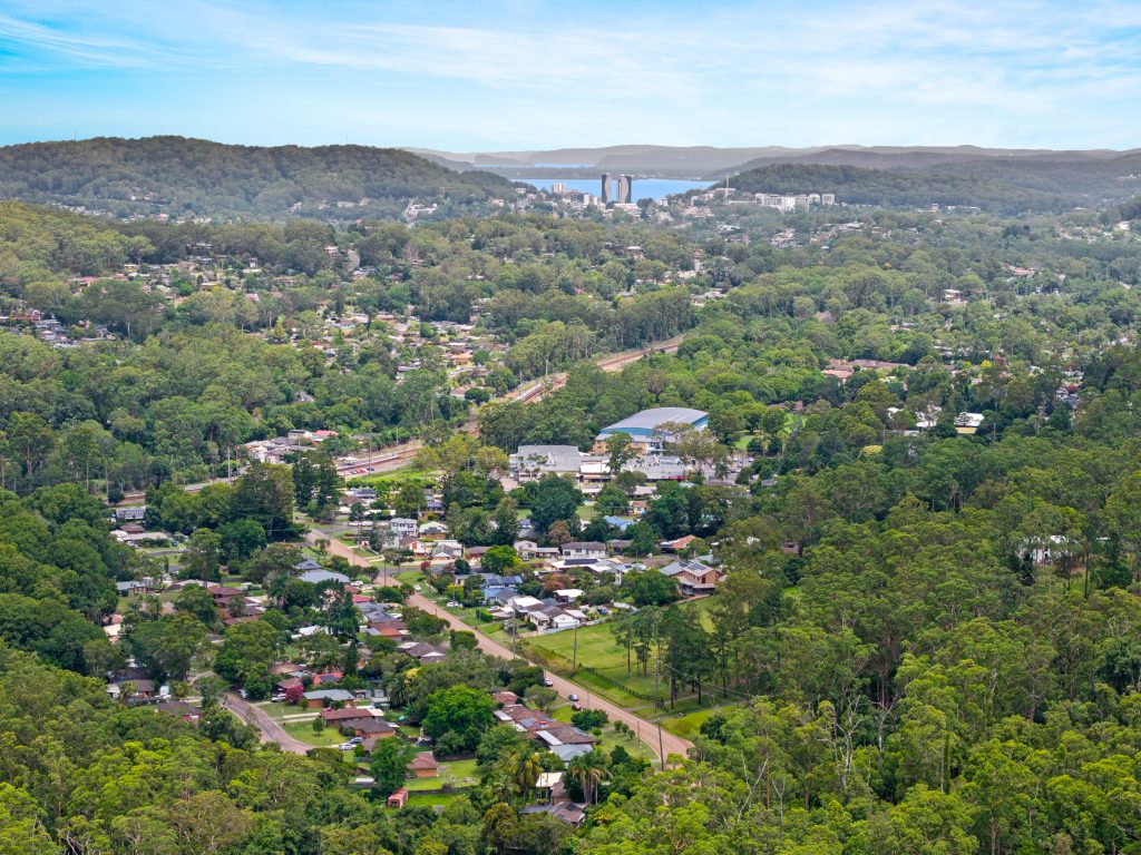 Aerial view over Niagara Park NSW with the rail line and Gosford in the distance