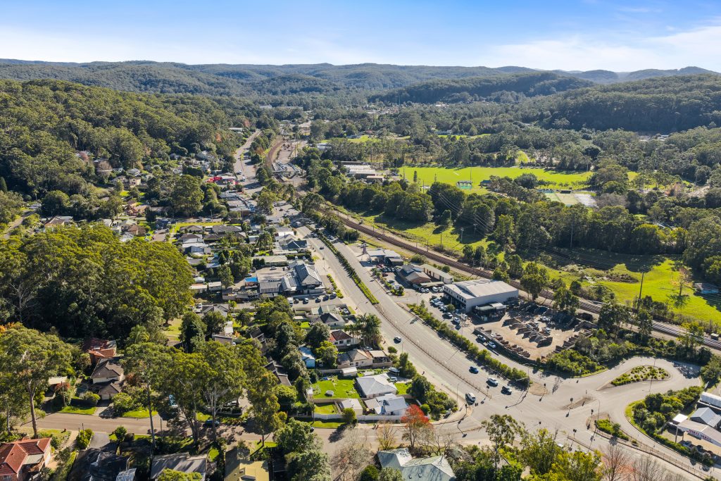 Aerial view over Ourimbah NSW showing the Pacific Highway, the railway line and the village centre