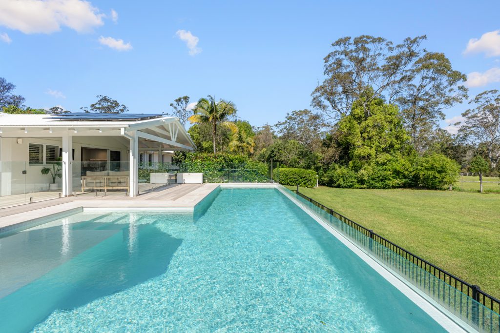 Swimming pool and covered outdoor living area looking out to paddocks at a Holgate property