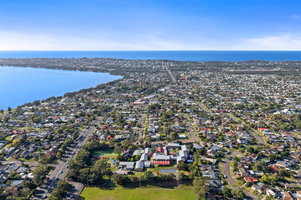 Aerial view over Killarney Vale NSW with Tuggerah Lake on one side and the ocean beyond