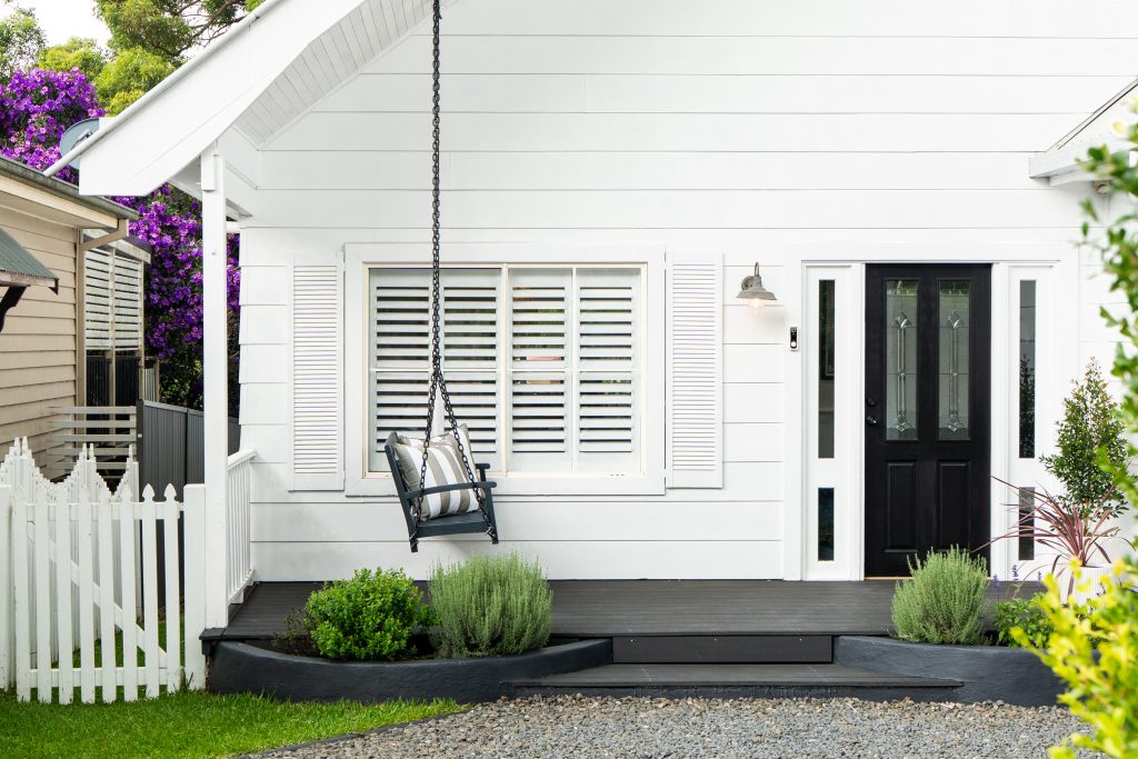 A weatherboard cottage with a front porch and picket fence in Springfield NSW